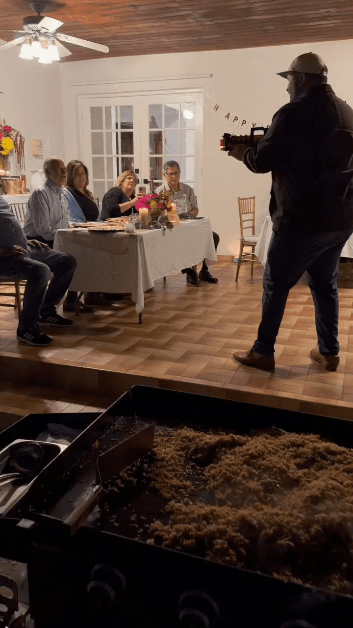 family and friends watching a hibachi chef at home